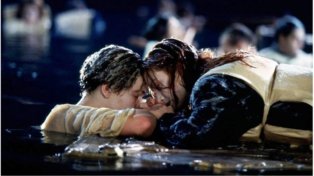 Still from Titanic (1997) showing Jack and Rose floating in the ocean head-to-head.