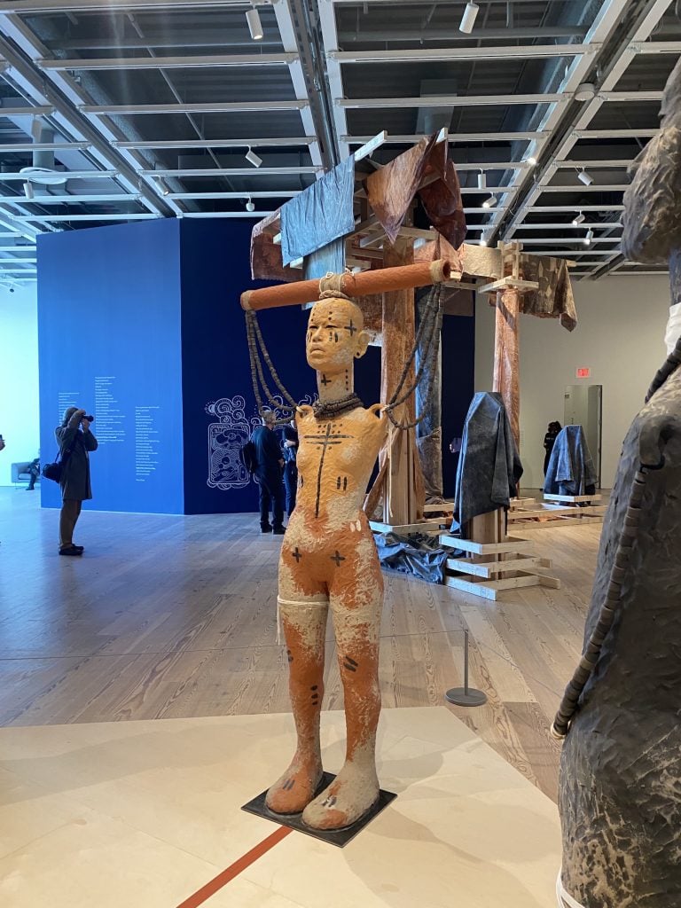 A standing sculpture with Native American imagery by Rose B. Simpson at the Whitney Biennial