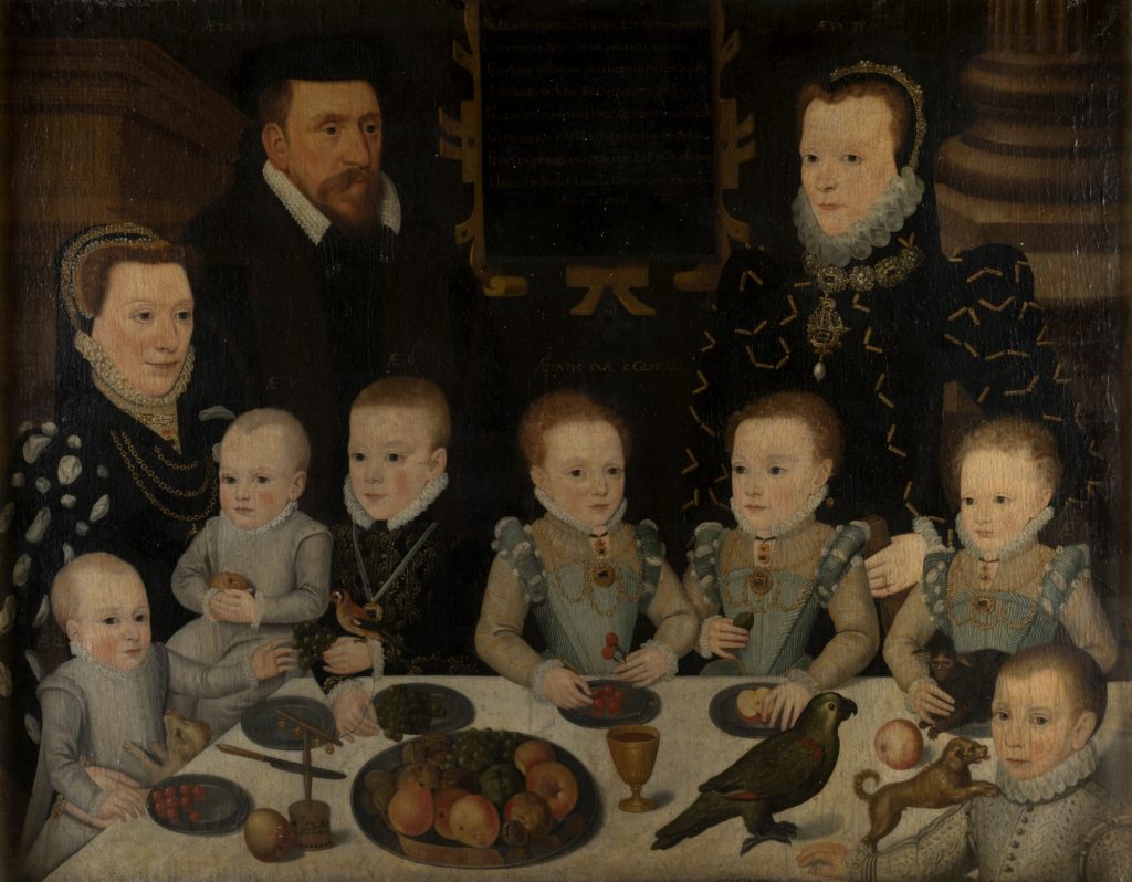 a formal family Stuart portrait with lots of small children dressed in similar outfits to their two parents.