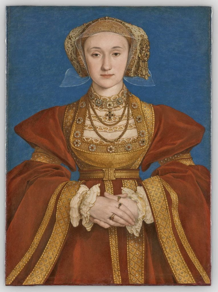 A 16th-century portrait of a woman in a fine, red robe, wearing gold rings and necklaces, seen post-restoration.