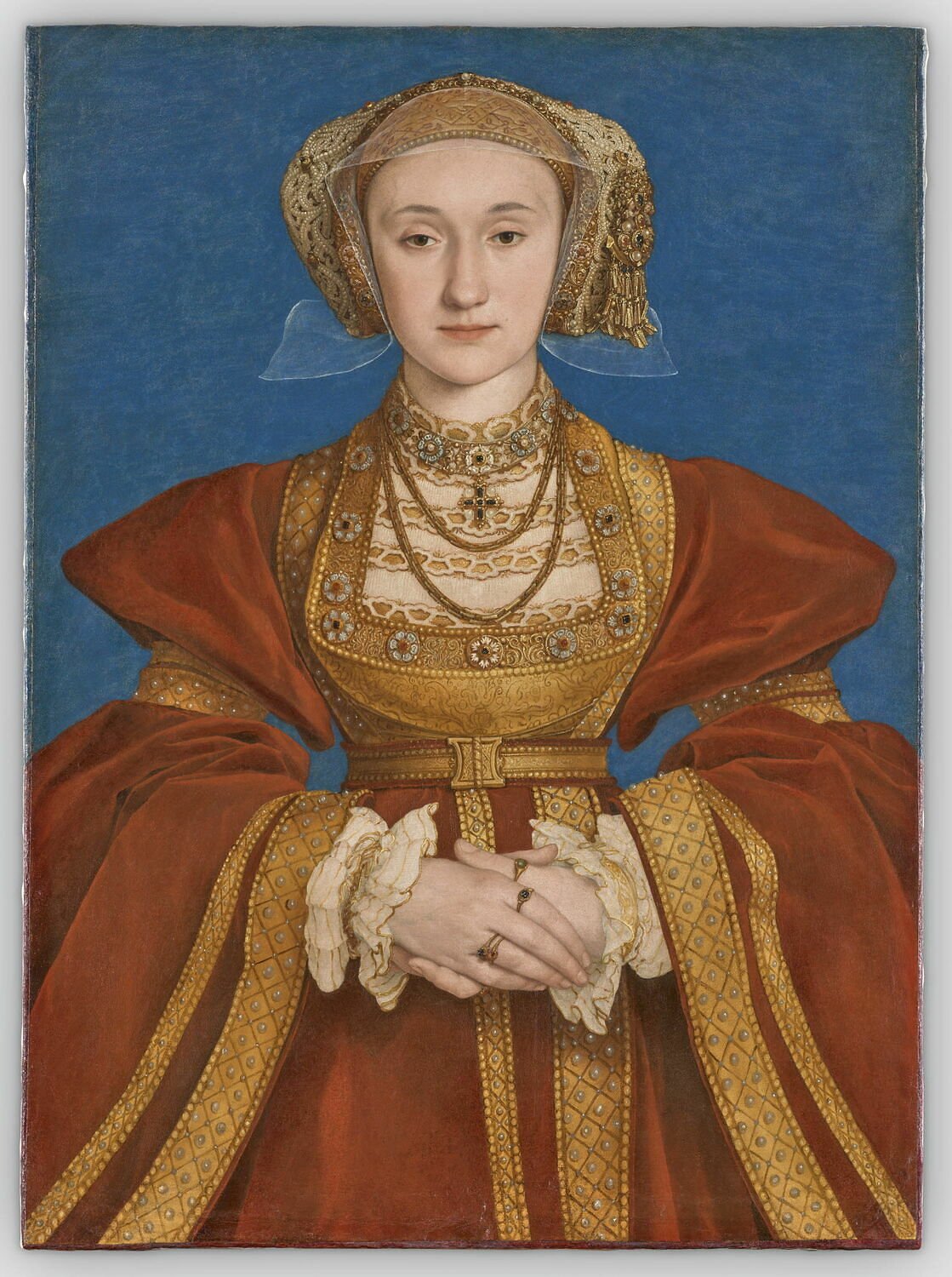 A 16th-century portrait of a woman in a fine, red robe, wearing gold rings and necklaces, seen post-restoration.