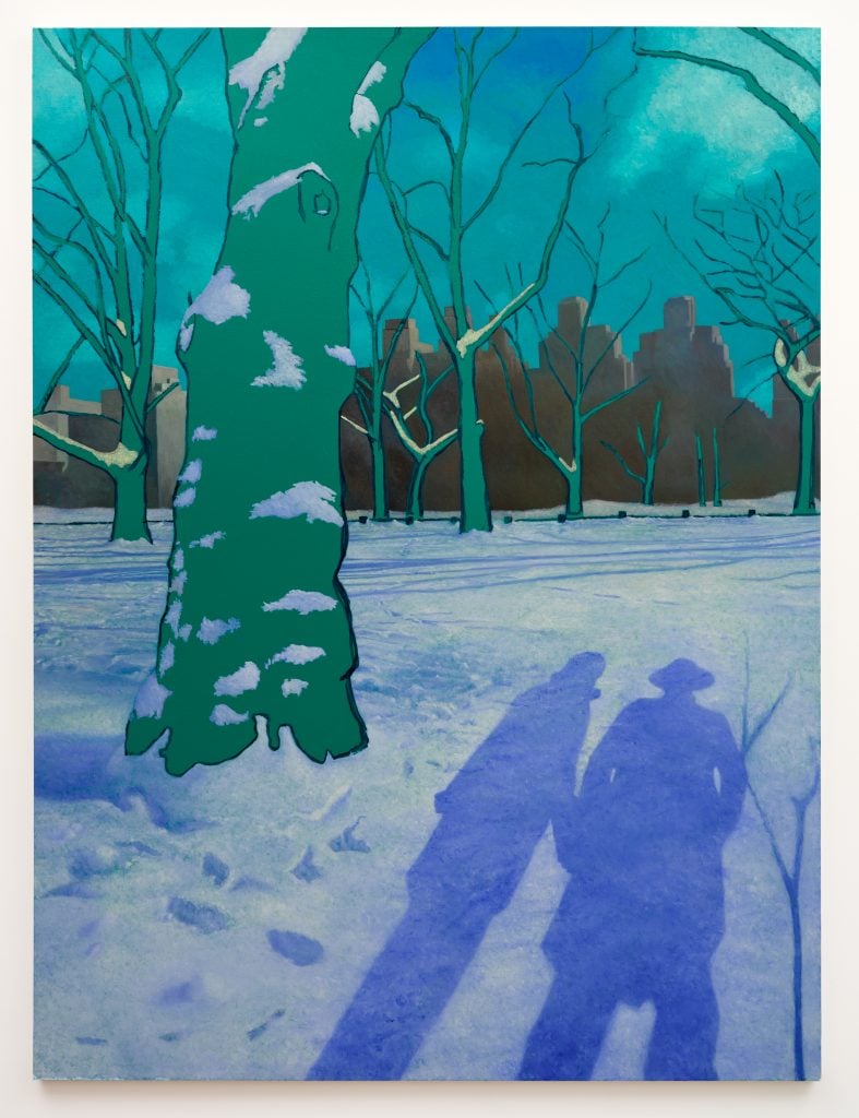 View of central park in the snow with the shadows of two people standing among trees that are painted bright teal.