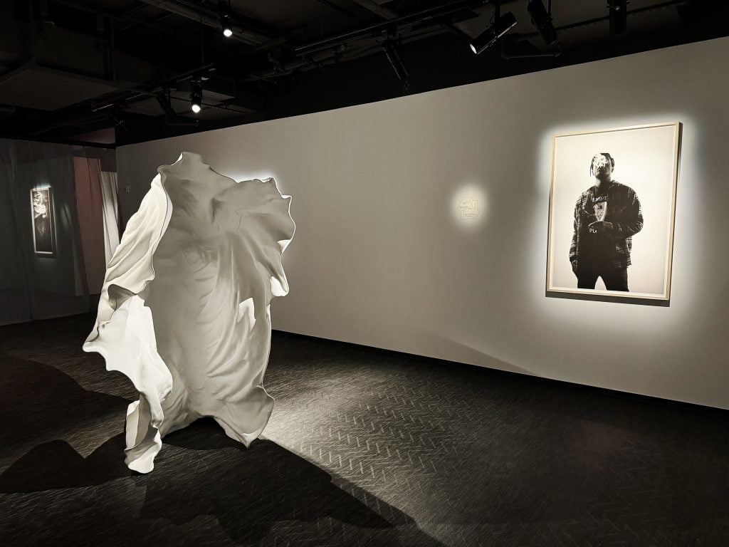A gallery installed with a sculpture of a sheet and a picture of rapper A$AP Rocky.