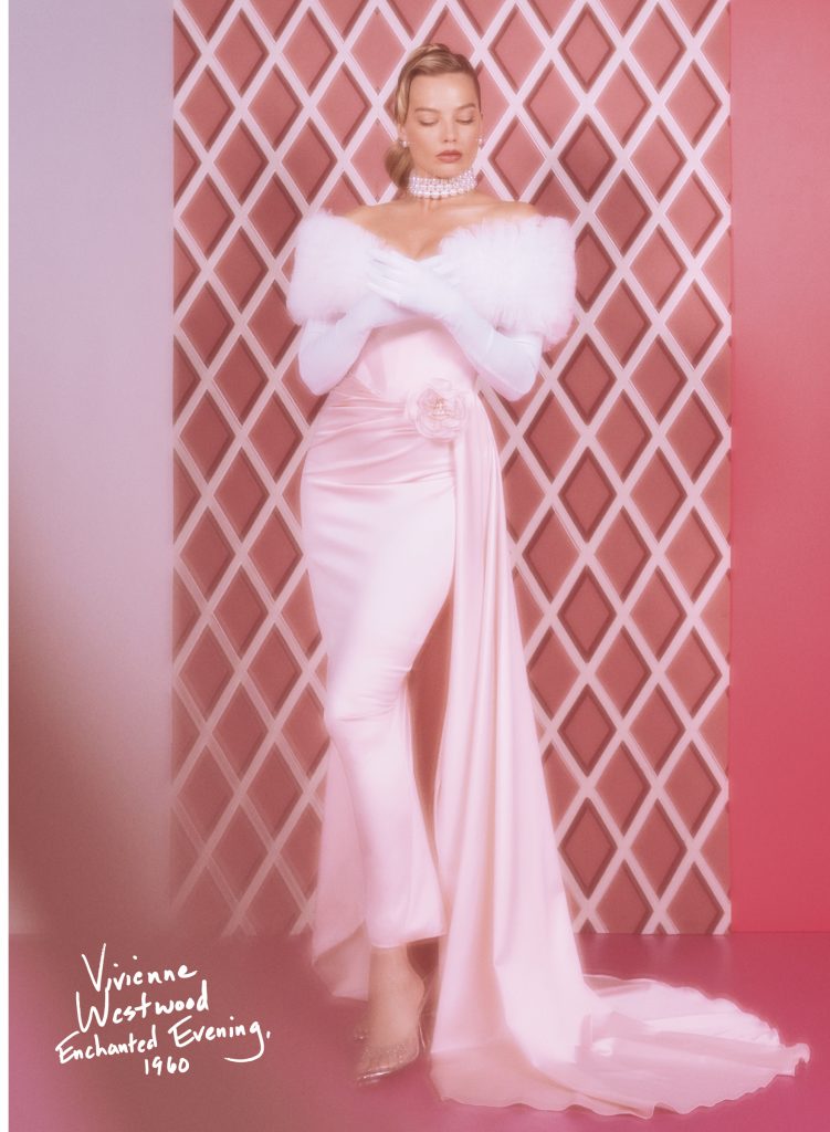 Margot Robbie wears a pink Vivienne Westwood long dress and a white boa.