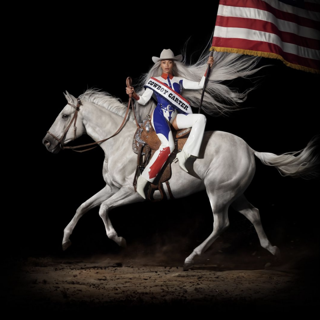A photograph of singer Beyoncé holding an American flag atop a galloping white horse on a black background