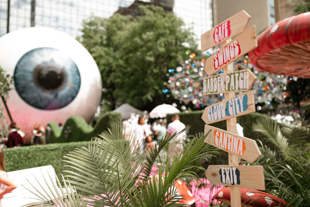 a giant eyeball sculpture is set up in a garden atmosphere