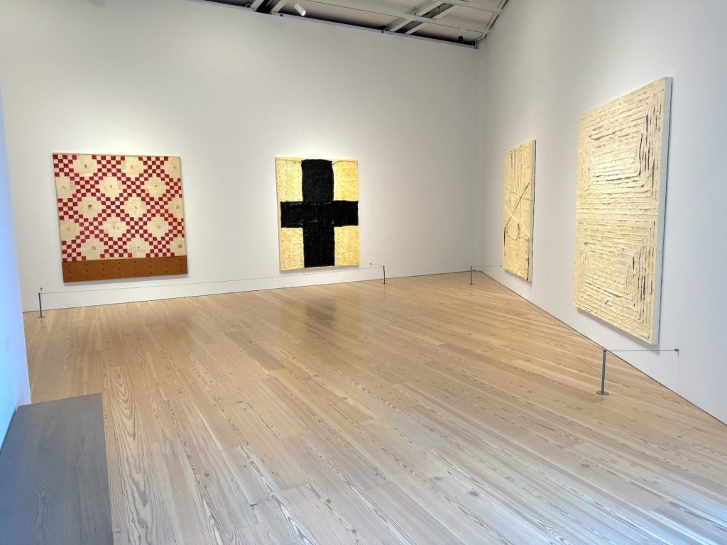 A gallery with four abstract paintings