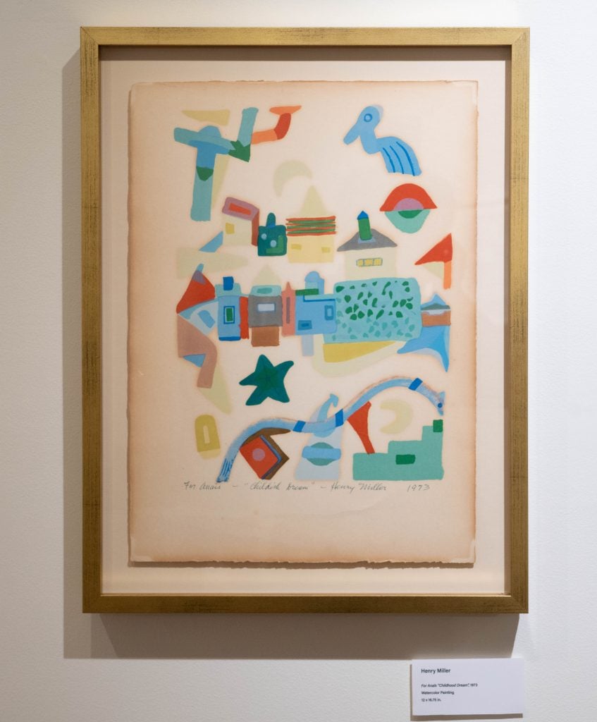 A photograph of a framed abstract painting in soft childlike colors