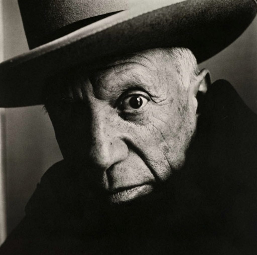 Close-up black and white portrait of artist pablo picasso wearing a hat.
