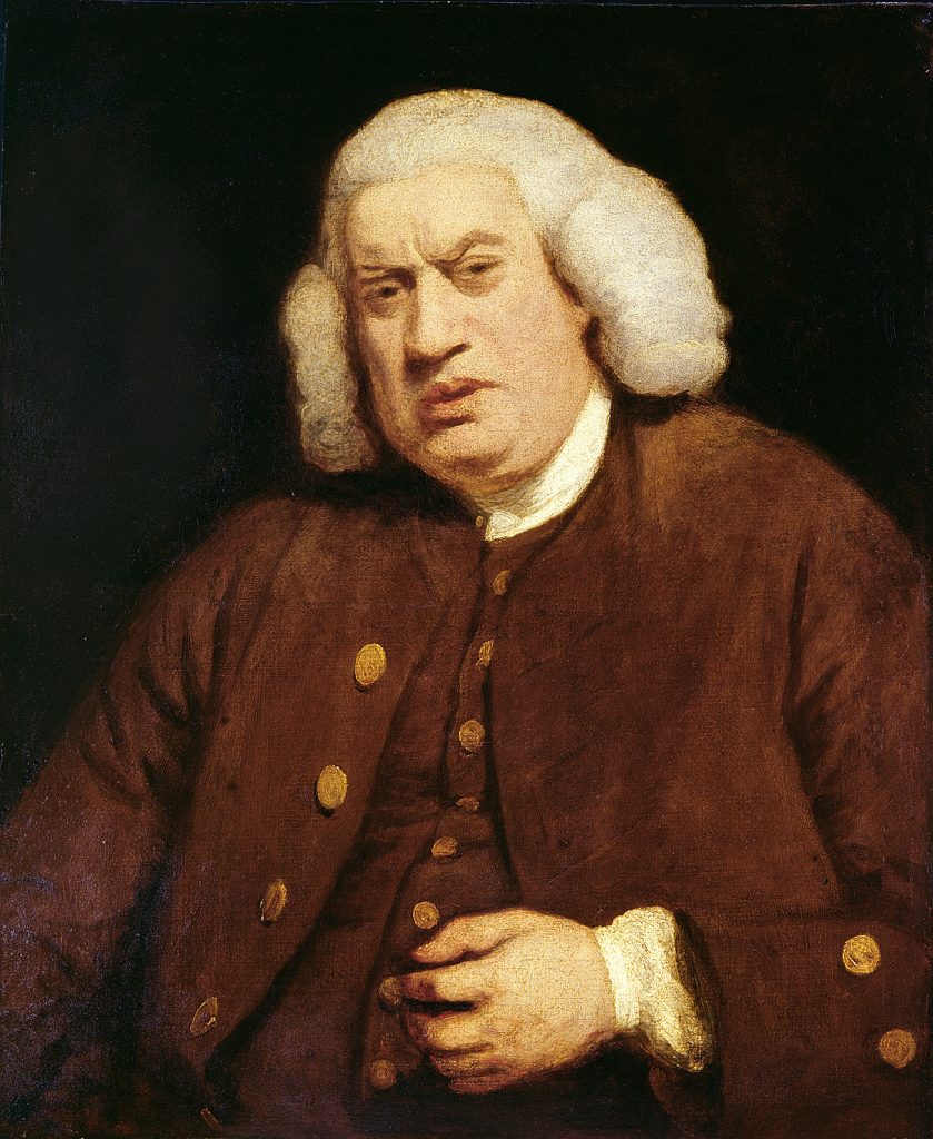 A man in a white wig and brown coat with a befuddled expression on his face.