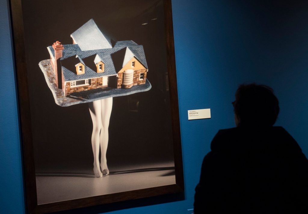 a video of a house attached to a pair of legs comments on domesticity and womanhood