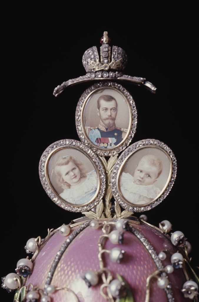 A bejewelled Faberge egg topped by small portraits depicting Tsar Nicholas II of Russia and his two oldest daughters, Olga and Tatiana.