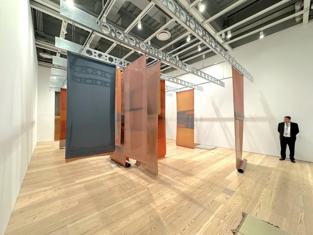 A gallery full of hanging sheets of tanned film