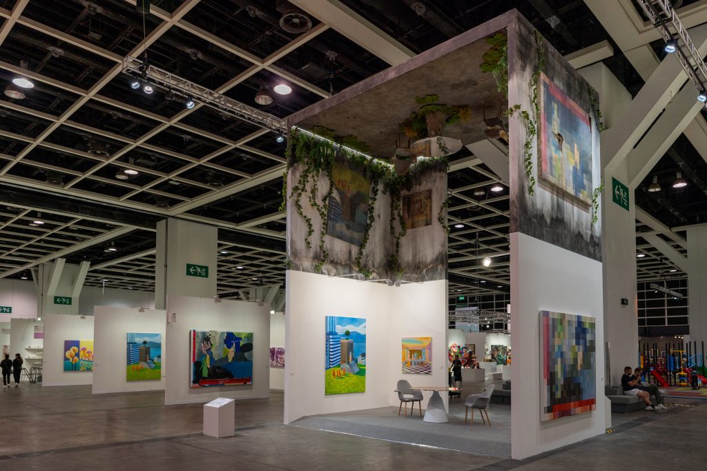 This is an image showing a monumental installation that appears to be replicating an art fair gallery booth in various dimensions.