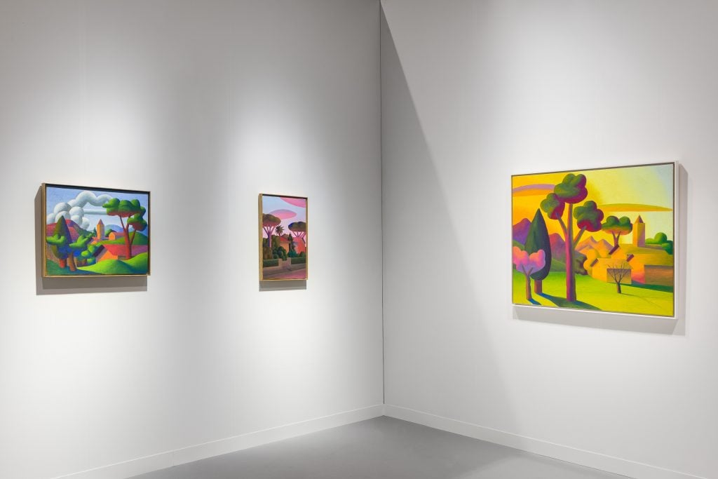 three colorful landscape paintings are hung on the walls of a gallery booth at art basel hong kong 2024