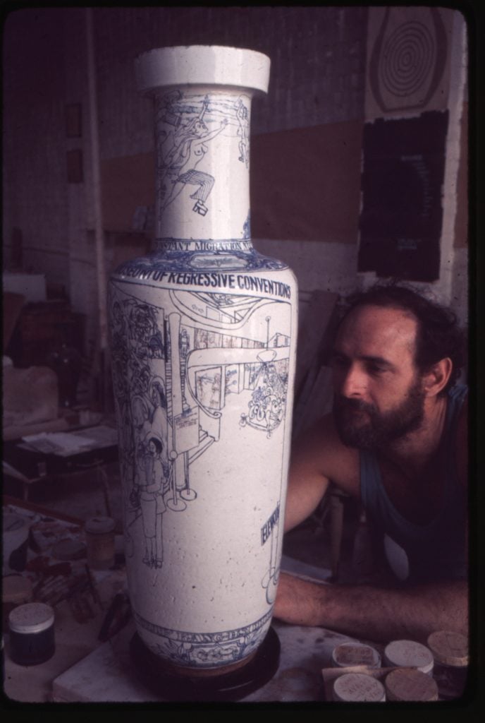 Vintage photo of a man with a beard painting a large white vase