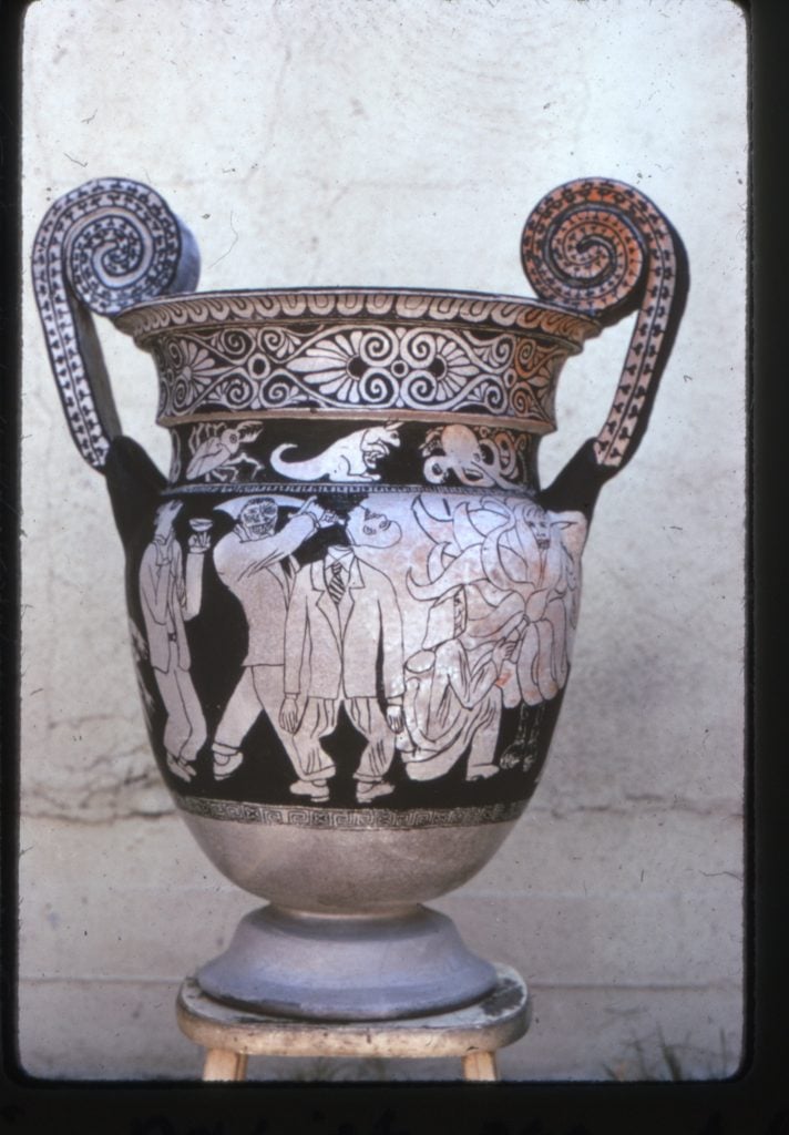 a black and white krater vase with decorative bands and imagery of men in suits
