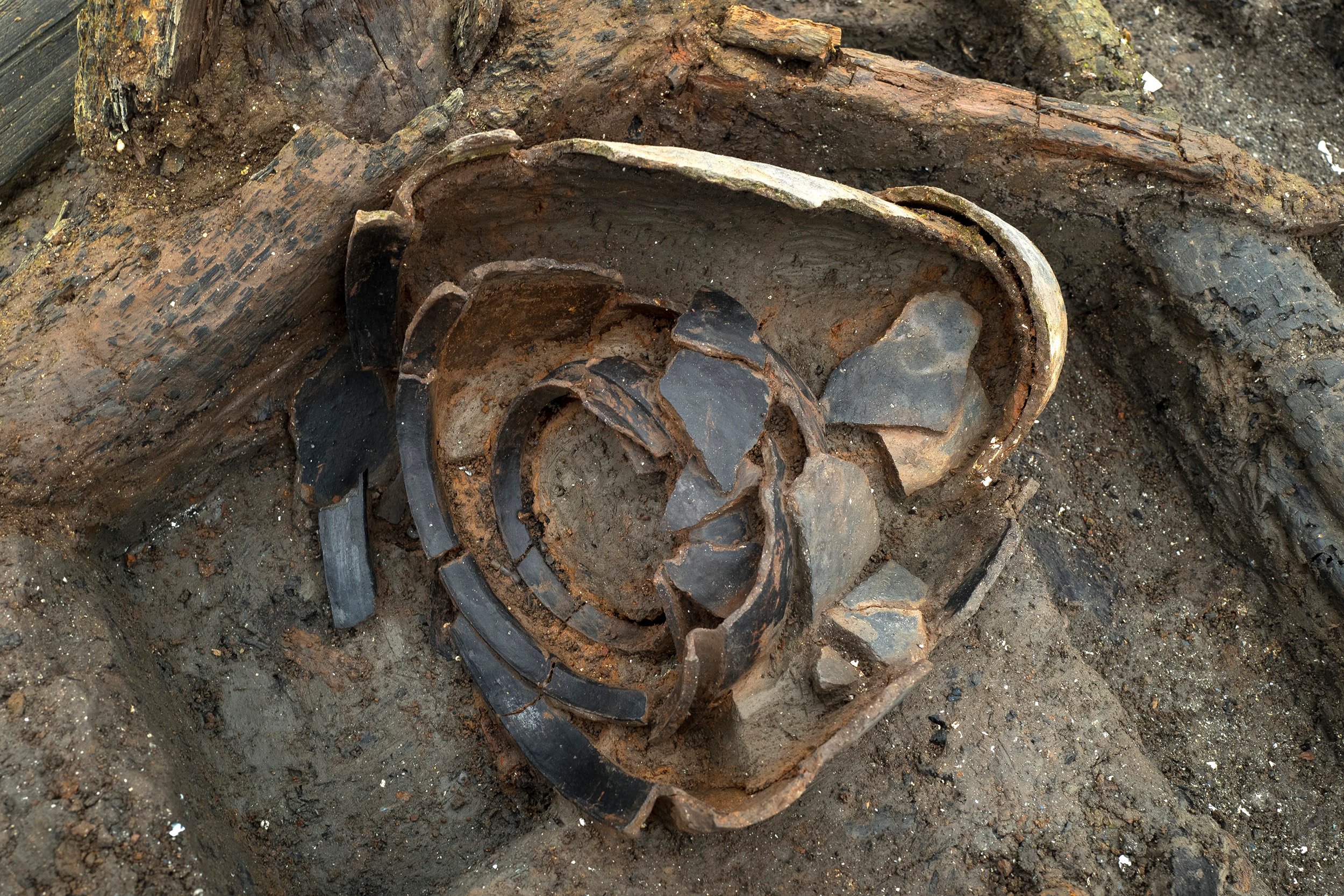 Cracked pottery against a wet ground in Must Farm, the U.K.