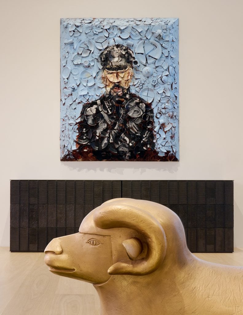 A mixed media portrait of Peter Marino hangs over one of the architect's bronze "boxes. A Les Lalanne sheep is in the foreground.