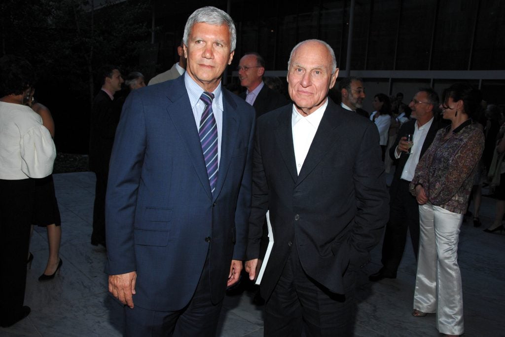 Two men, gallerist Larry Gagosian and artist Richard Serra, posing in suits.
