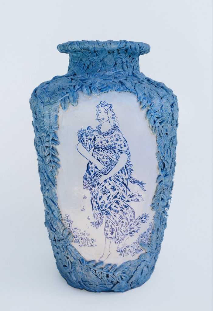 a blue and white vases with decorative leaves and a painting of a woman in a floral dress taken from Botticelli's Primavera