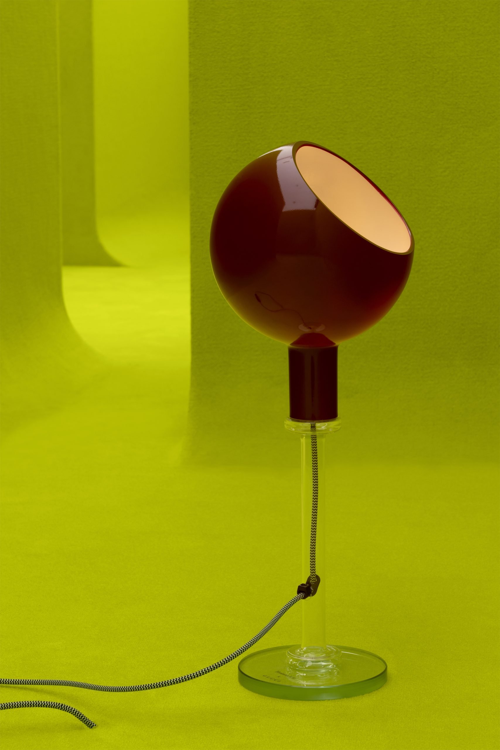 a modern oxblood lamp is in an acid green Gucci maze