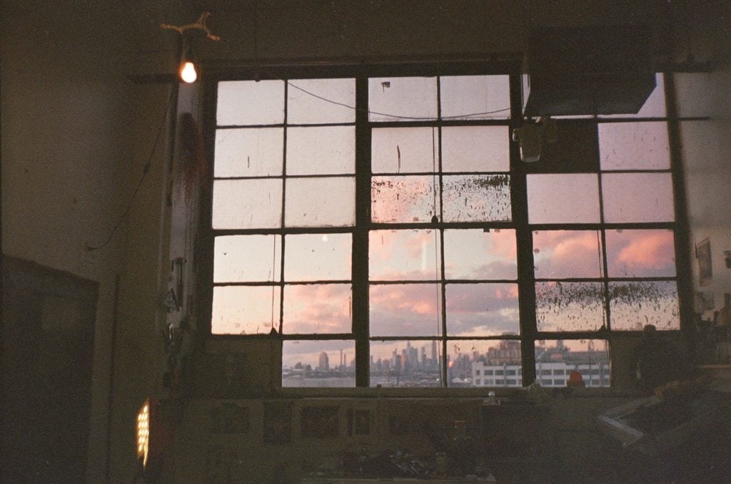 The view of the Manhattan skyline at sunset through a windowpane. 