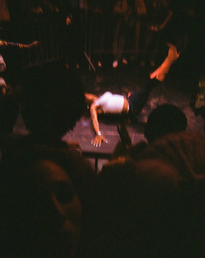A woman dancing on the floor at a party. 