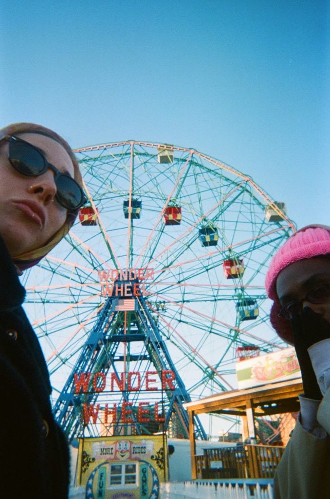 A selfie taken in front of the Ferris wheel at Coney Island. 
