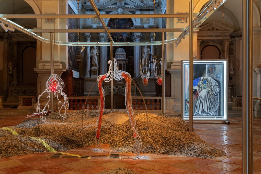 art installation in a church showing dangling corporeal body parts 