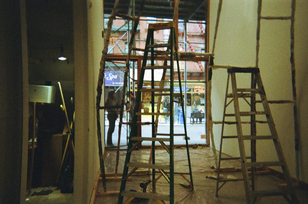 Ladders at the entrance of an art gallery. 