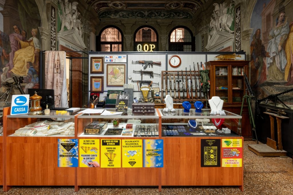 an old church marble interior filled with clutter and random found objects with a display of guns