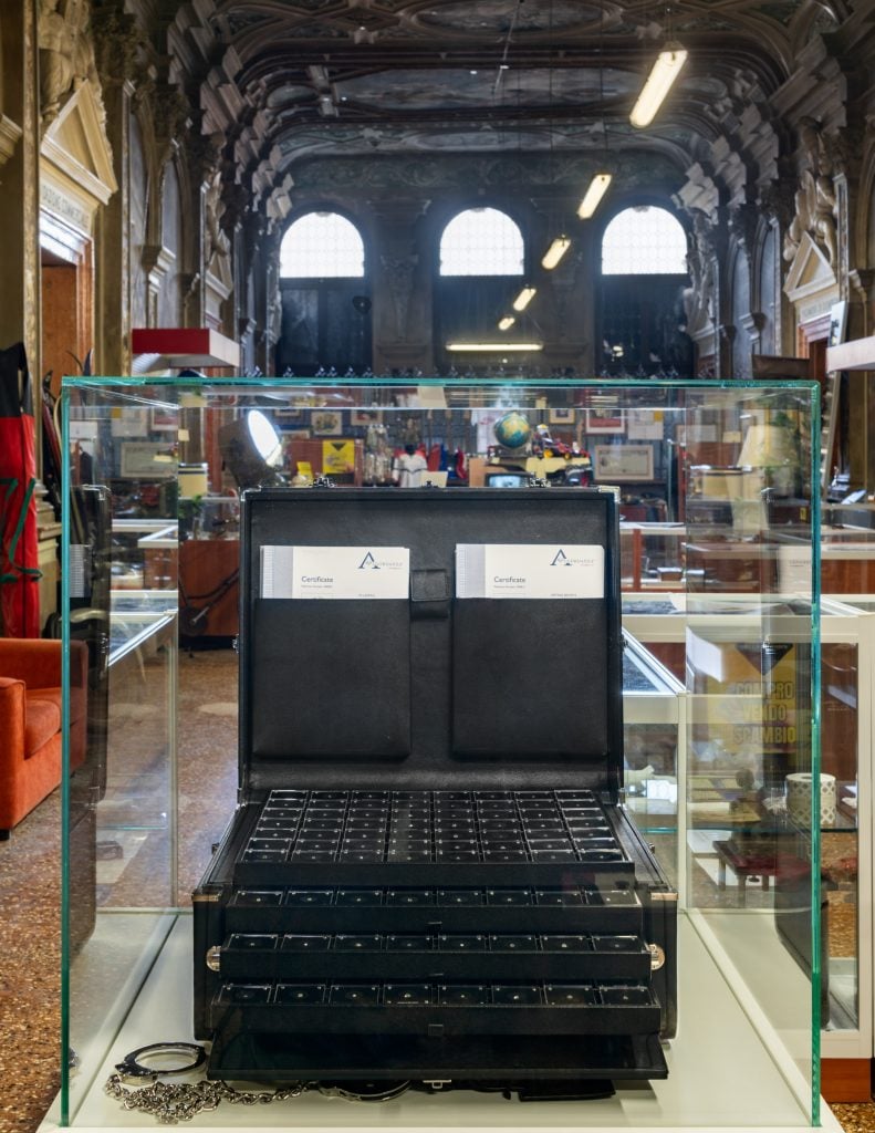 a case full of diamonds inside a glass case in a large grand marble church interior