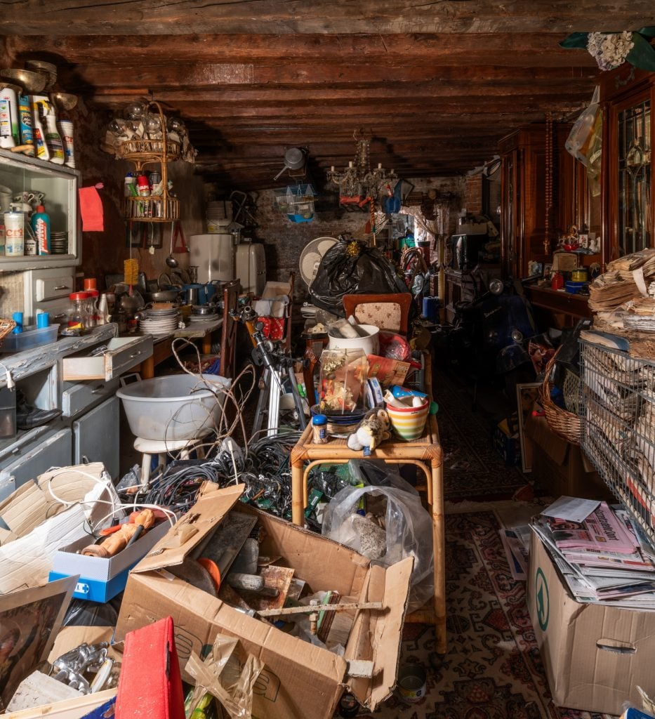 a wooden basement room interior filled with clutter and random found objects