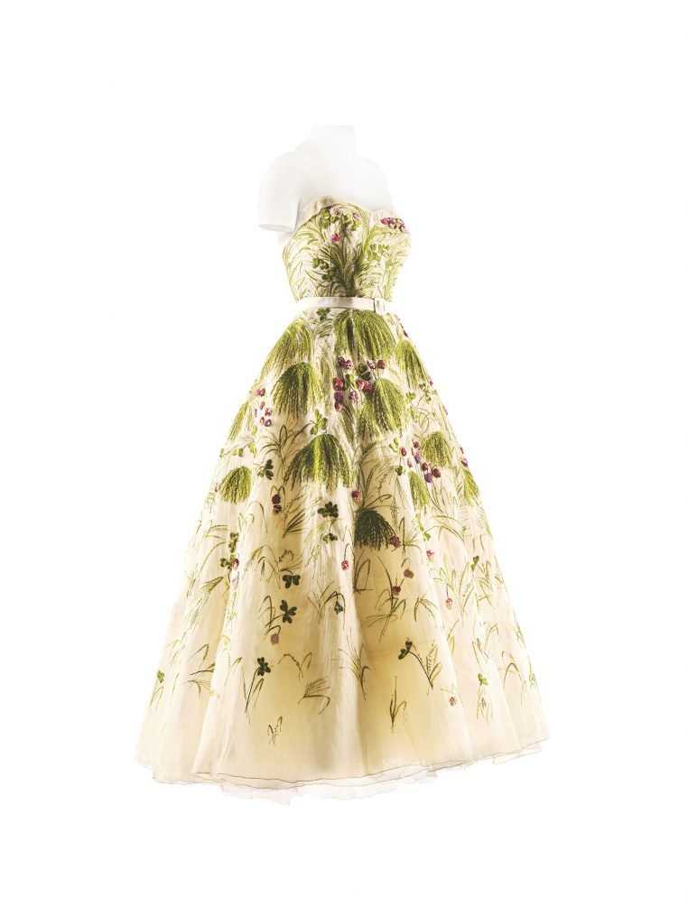 A cream ballgown by Christian Dior with floral details
