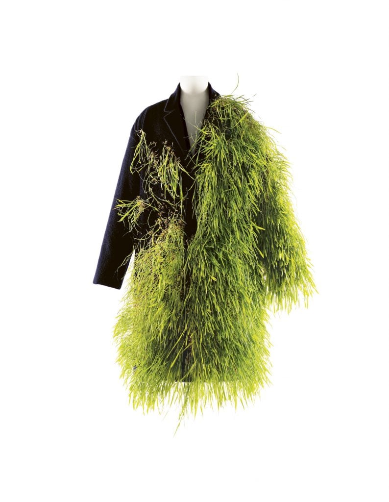 A black coat by Loewe stuck with living grass.