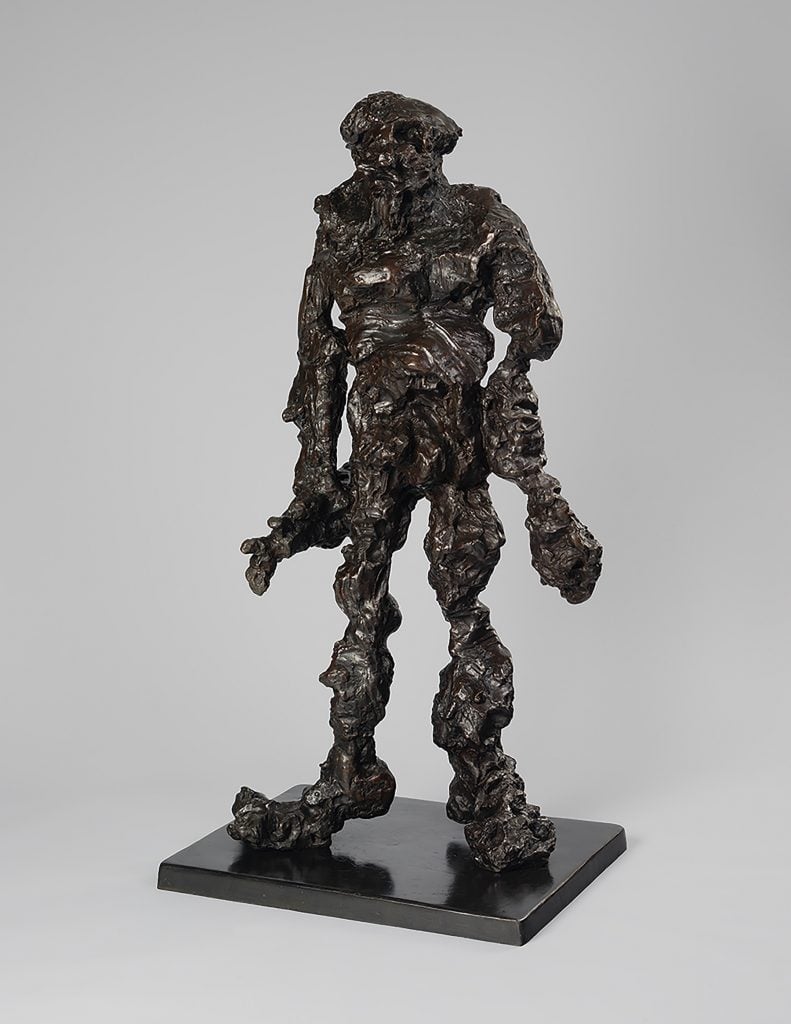 an image of Clamdigger a bronze statue of a man modeled in rough shapes and outlines
