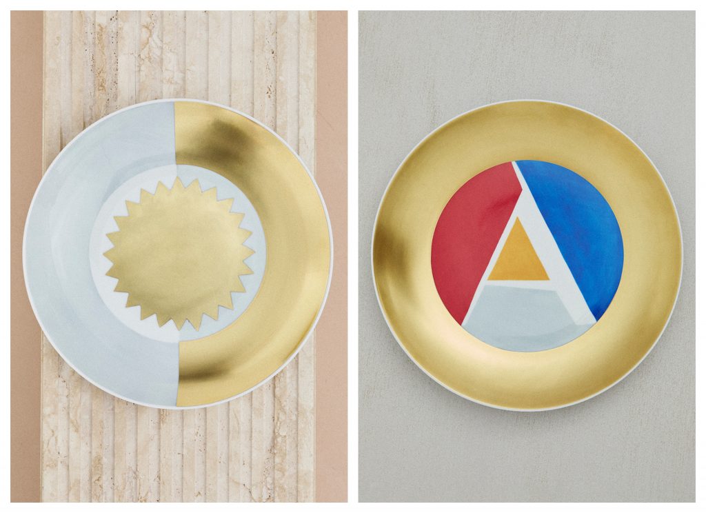 two golden dishes wit ha sun and an "A" design 
