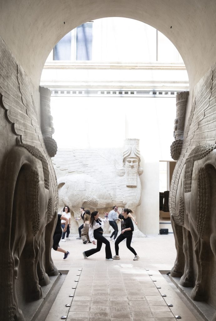 Dancers dance in an Assyrian temple in the Louvre