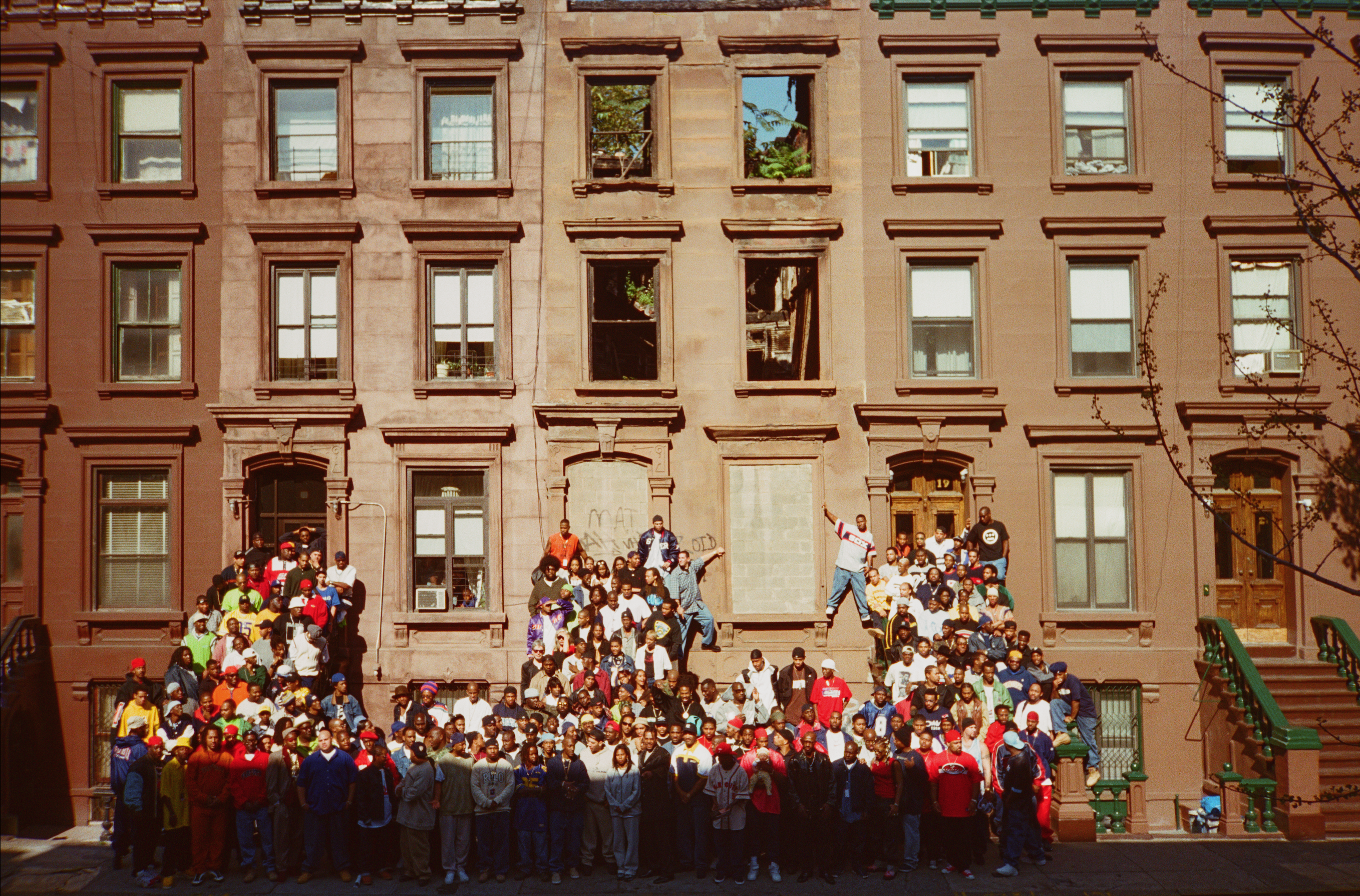 A group of 177 people, all hip-hop figures in New York, gathered around a stoop in Harlem