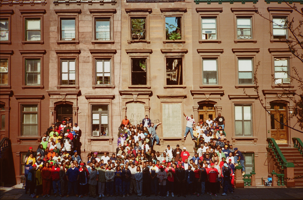 A group of 177 people, all hip-hop figures in New York, gathered around a stoop in Harlem