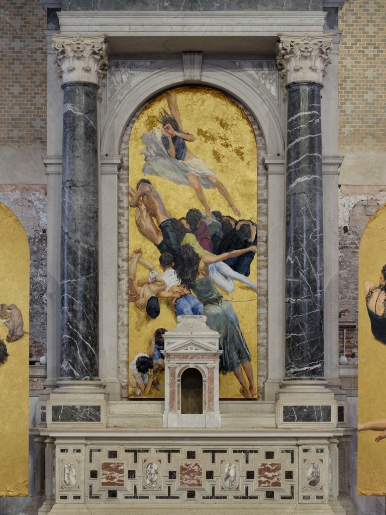 A series of gold painted panels on view in a Venice exhibition space