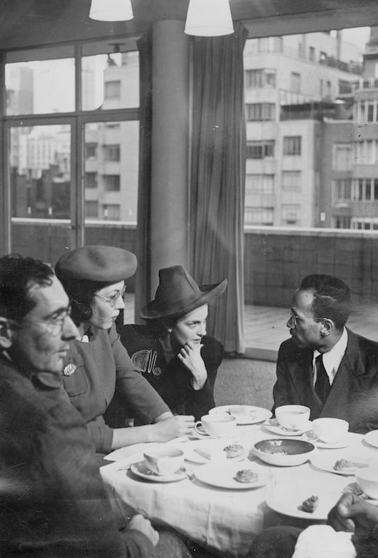 A group of two women and two men sitting around a table at a restaurant in deep conversation