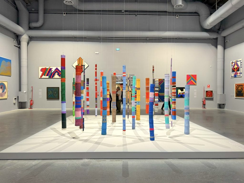 A series of colorfully painted bamboo sculptures