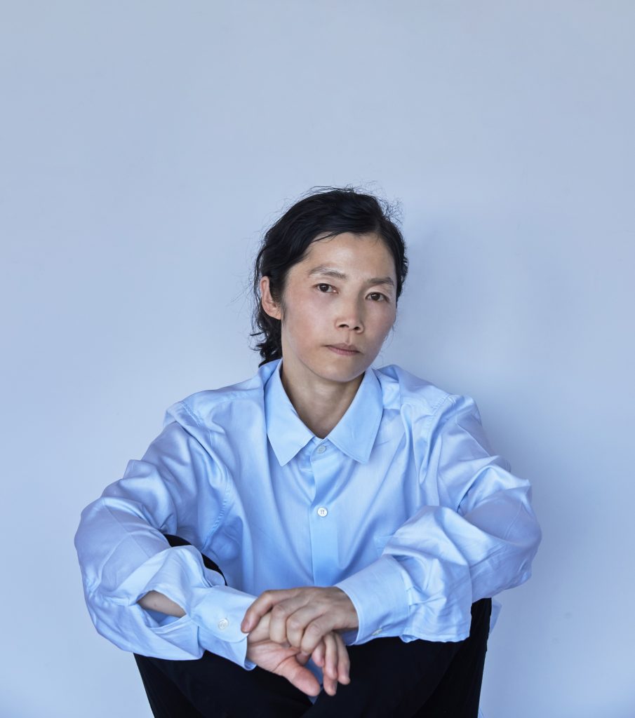 This image is a portrait of a non-binary Asian artist Koo Jeong A.