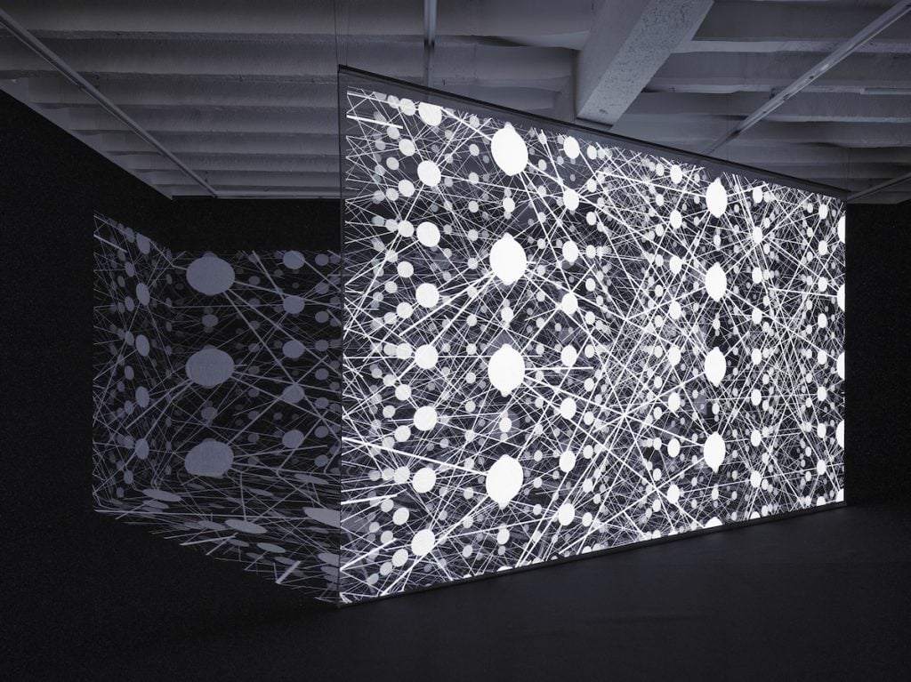 a video installation of a black and white abstraction artwork of dots and lines