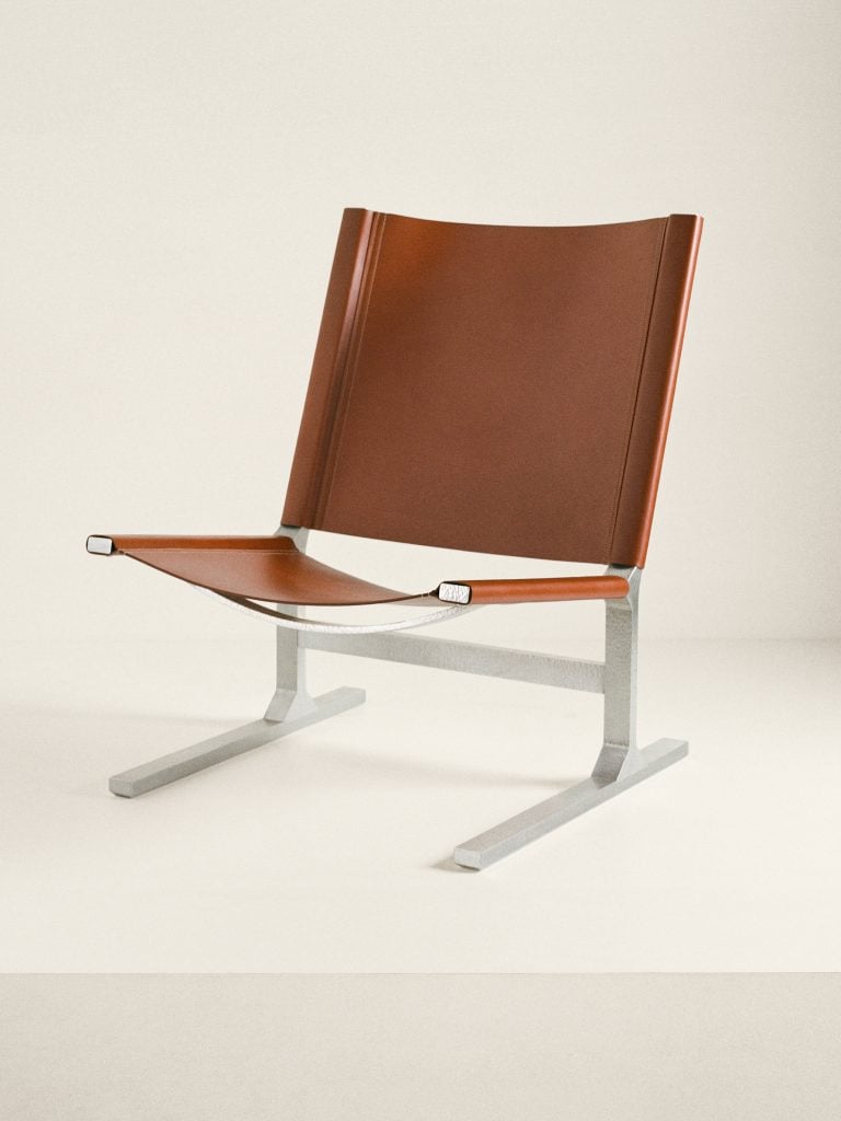a brown leather and aluminum designer lounge chair 