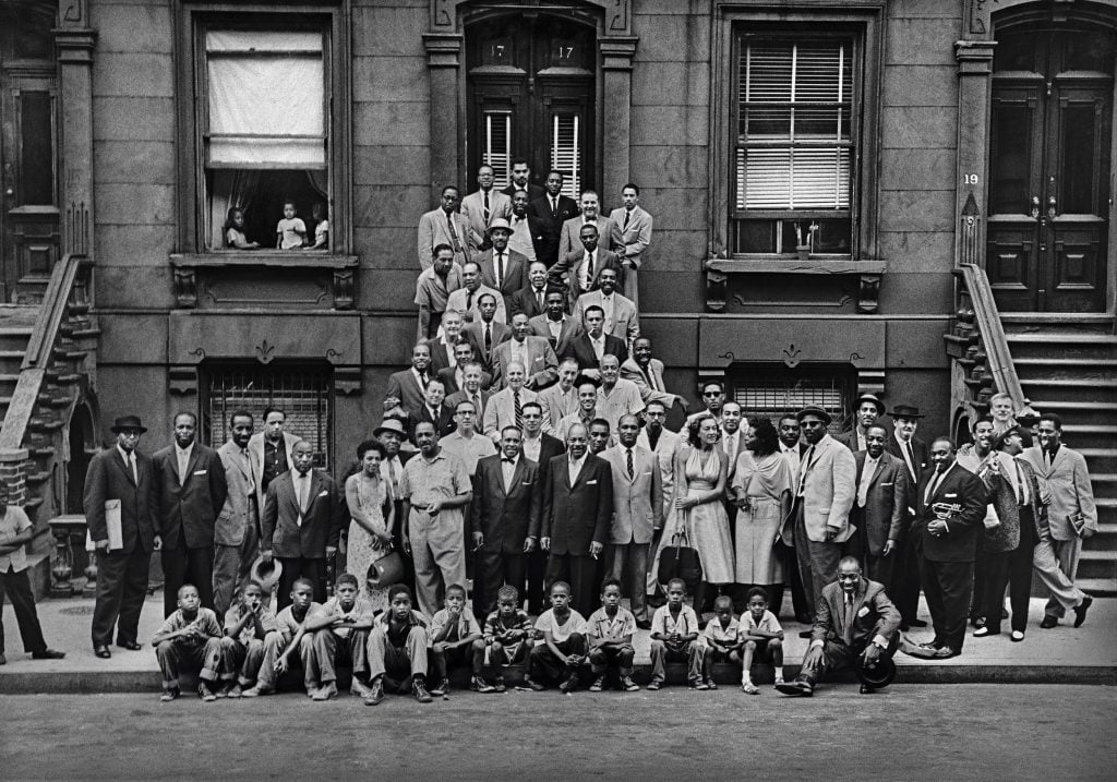 Art Kane's iconic black-and-white photograph of a group of jazz luminaries gathered around a stoop in Harlem.