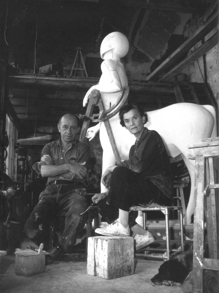The married artist duo Les Lalanne sit in front of an in-progress large centaur sculpture.