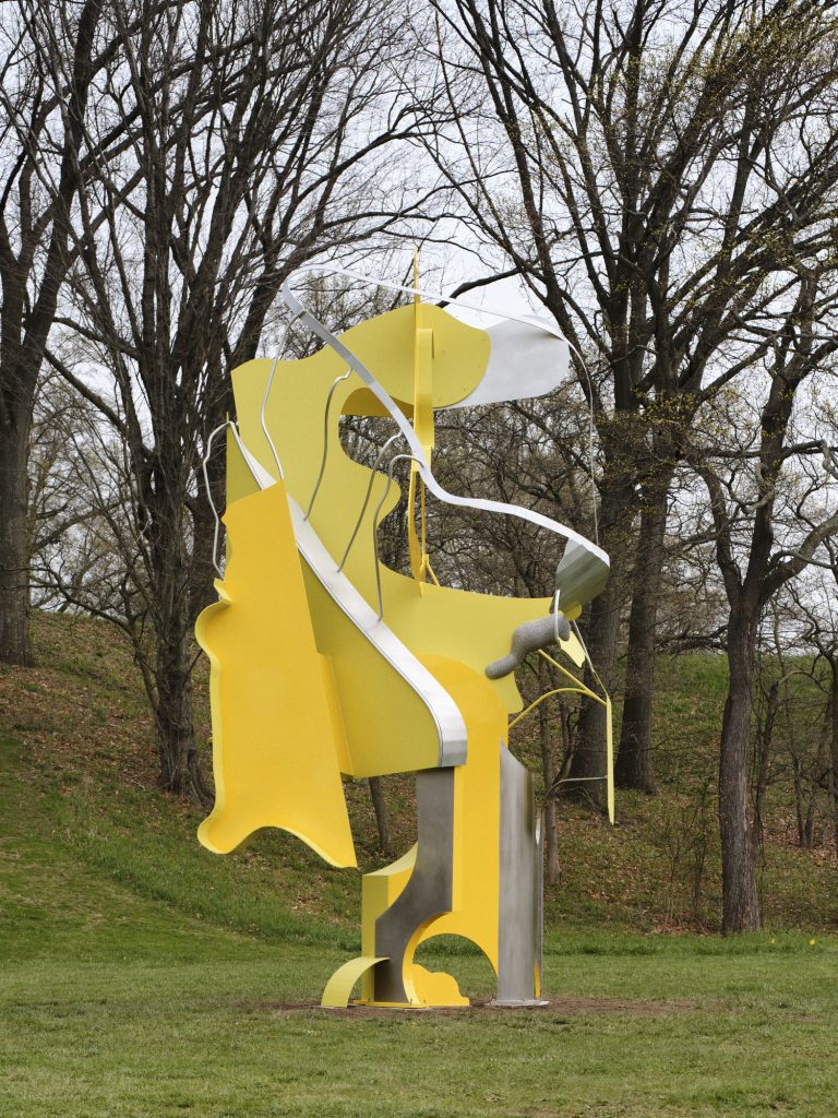 an abstract outdoor sculpture with playful yellow shapes by arlene shechet